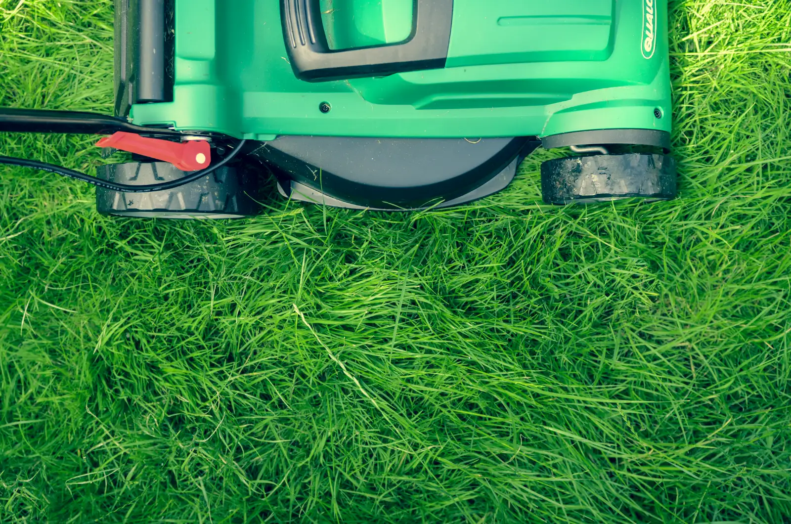 A lawn mower on freshly cut grass